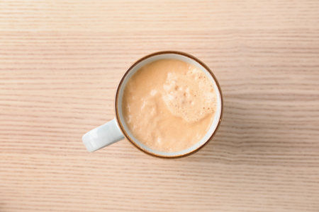 Cup of aromatic hot coffee on wooden background, top viewの写真素材