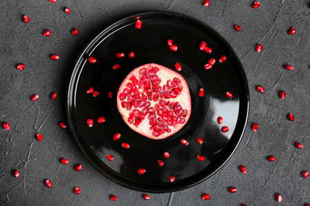 Plate with pomegranate on dark backgroundの写真素材