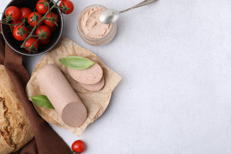 Delicious liver sausages, paste and cherry tomatoes on light gray table, flat lay. Space for textの写真素材