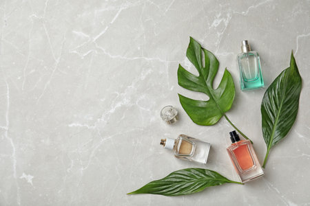 Flat lay composition with bottles of perfume on gray backgroundの写真素材