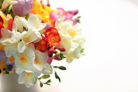 Beautiful bouquet of freesia flowers on light backgroundの写真素材