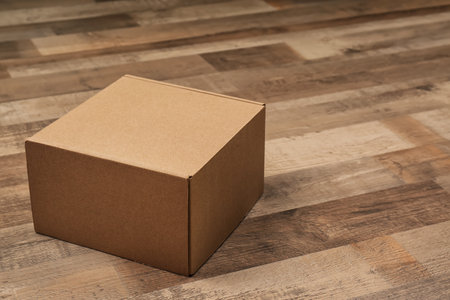 Cardboard box on wooden floor