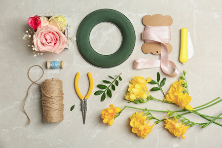 Florist equipment with flowers on light background, top viewの写真素材