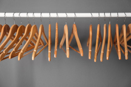 Clothes rail with wooden hangers on gray backgroundの写真素材