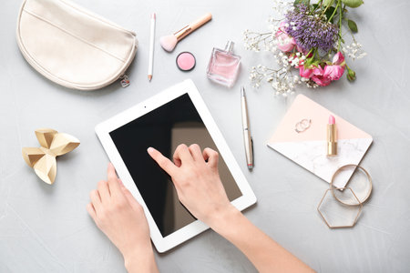 Blogger using tablet at table, top viewの写真素材