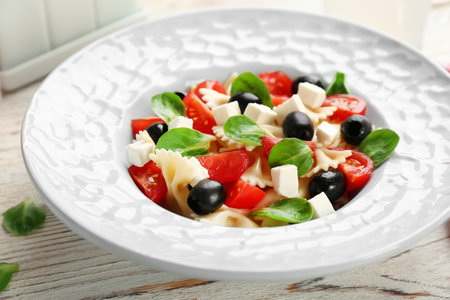 Plate with delicious pasta primavera on tableの写真素材