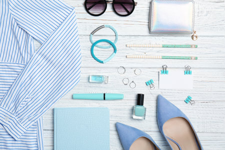 Flat lay composition with clothes, cosmetics and stylish accessories on light backgroundの写真素材