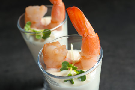 Glasses with boiled shrimps and sauce on gray backgroundの写真素材