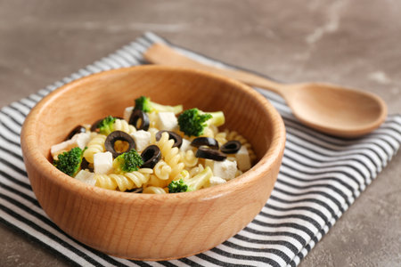 Wooden bowl with delicious pasta primavera on tableの写真素材
