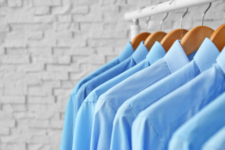 Rack with clean clothes on hangers after dry-cleaning indoorsの写真素材