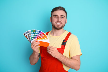 Male decorator with palette on color backgroundの写真素材