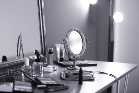 Different makeup products on dressing table, black and white effectの写真素材