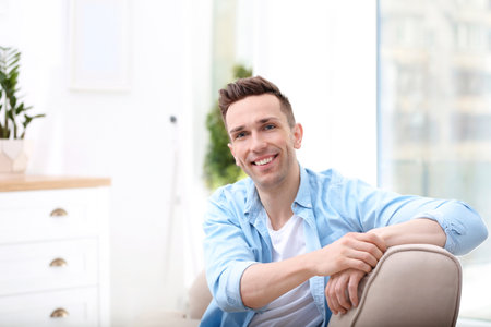 Young man resting on sofa at homeの写真素材