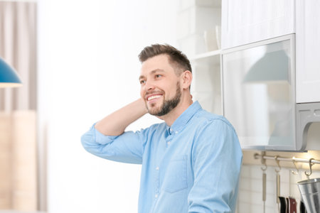 Portrait of a handsome young man in the kitchenの写真素材