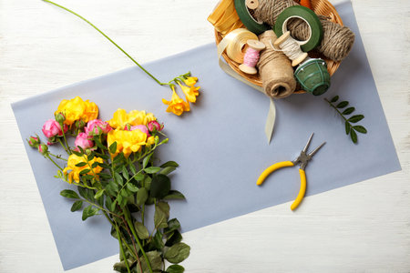 Florist supplies with flowers on wooden background, top viewの写真素材