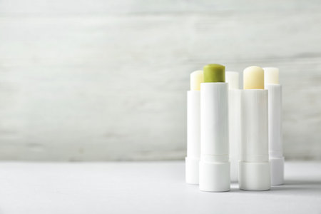 Hygienic lipsticks on table against light backgroundの写真素材