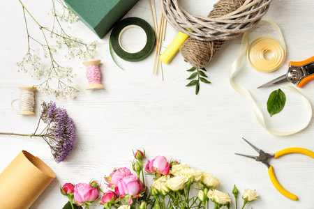 Florist equipment with flowers on wooden background, top viewの写真素材