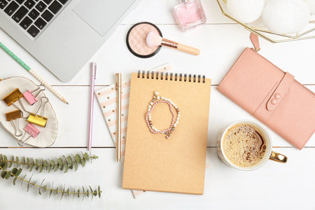 Set of accessories, cosmetics and laptop on wooden background, flat lay. beauty bloggingの写真素材