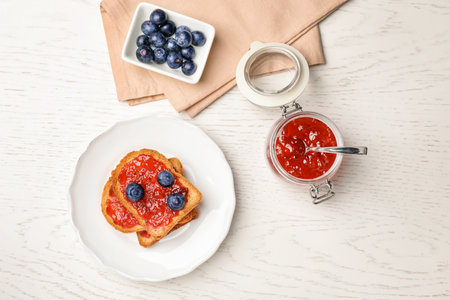 Toasts with jam and berries on wooden background, top viewの写真素材