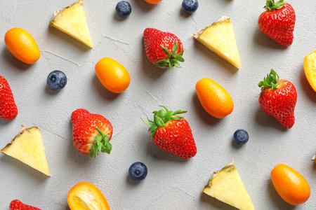 Flat lay composition with fresh berries and fruits on gray background