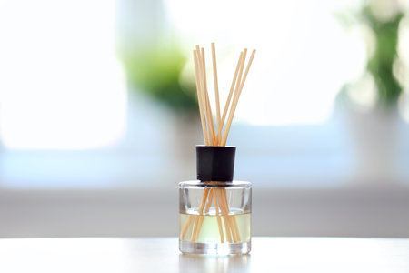Handmade reed freshener on table against blurred backgroundの写真素材