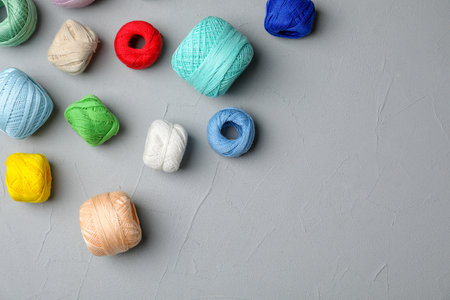 Color threads on gray background, top viewの写真素材