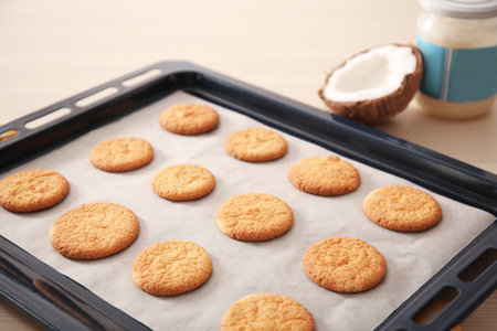 Baking tray with cookies and coconut on table, closeupの写真素材