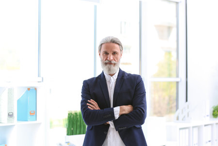 Portrait of handsome mature man in suit, indoors