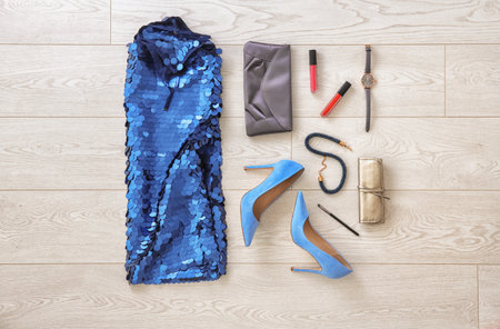 Set of female clothes and accessories on wooden background, flat layの写真素材