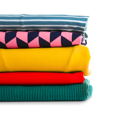 Stack of clean clothes on white backgroundの写真素材