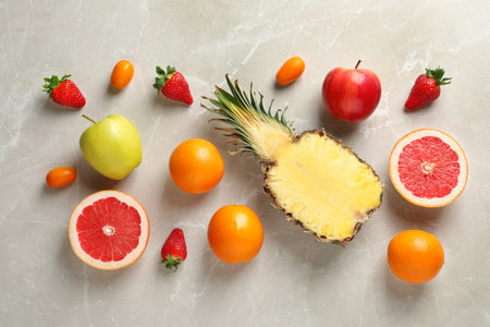 Flat lay composition with fresh fruits and strawberries on color backgroundの写真素材