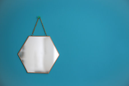 Mirror hanging on empty color wallの写真素材