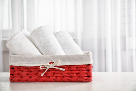 Basket with clean towels on tableの写真素材