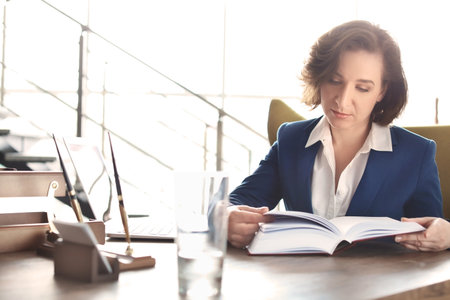 Female lawyer working at table in officeの写真素材