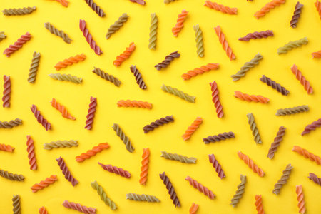 Flat lay composition with raw pasta on color backgroundの写真素材