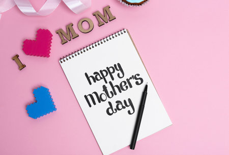 Notebook with phrase HAPPY MOTHER'S DAY on color backgroundの写真素材
