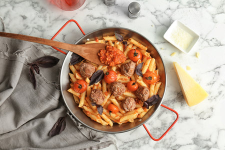 Pasta with meatballs and tomato sauce on light backgroundの写真素材