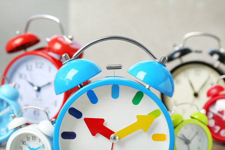 Blue alarm clock and many others on background. time change conceptの写真素材