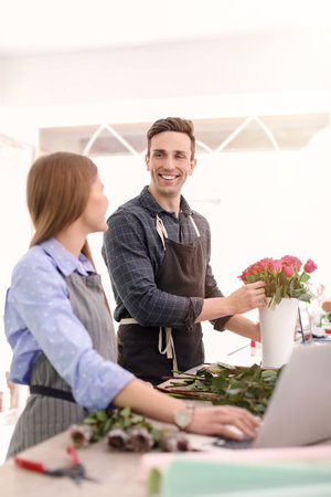 Male and female florists working in flower shopの写真素材