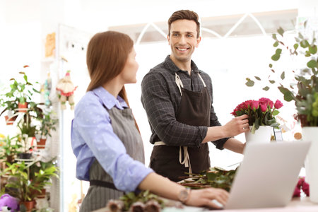 Male and female florists working in flower shopの写真素材