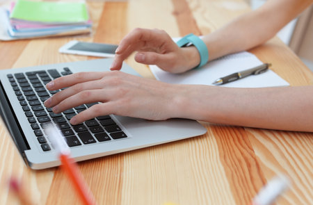 Young woman working with laptop at desk. home officeの写真素材