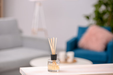 Handmade reed freshener on table against blurred backgroundの写真素材