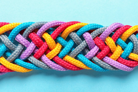 Braided ropes on color background, top view. unity concept