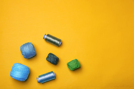 Flat lay composition with sewing threads on color backgroundの写真素材