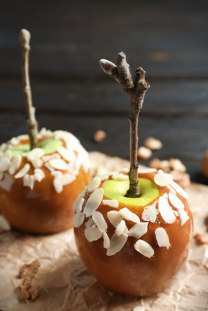 Delicious caramel apples on wooden backgroundの写真素材