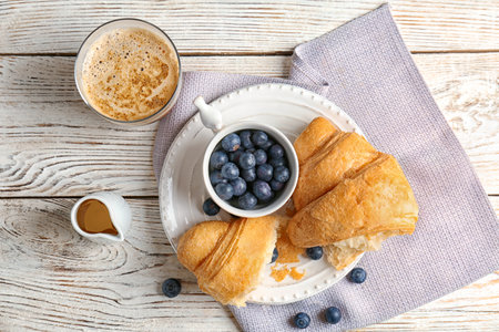 Tasty croissant with berries served for breakfast on plateの写真素材