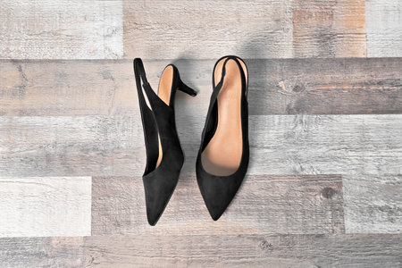 Pair of female shoes on wooden background, top viewの写真素材