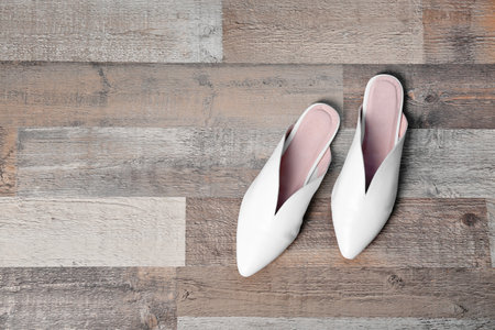 Pair of female shoes on wooden background, top viewの写真素材