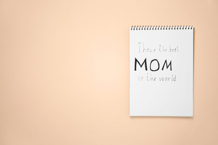 Notebook with text "I have the best mom in the world" on light background, top view. mother's day congratulationsの写真素材