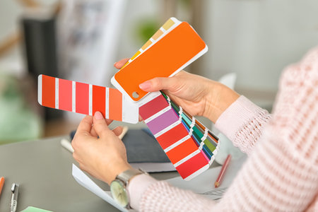 Female designer working with palette color samples at tableの写真素材